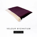 A luxurious Dog Burrow Bag, a sleeping bag style dog bed or snuggle sack style dog bed, with an outer cover in deep purple upholstery-quality Velour with a plush, cream faux-fur lining, and a badge with the colour name Byzantium on a white background.