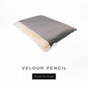 A luxurious Dog Burrow Bag, a sleeping bag style dog bed or snuggle sack style dog bed, with an outer cover in charcoal grey upholstery-quality Velour with a plush, cream faux-fur lining, and a badge with the colour name Pencil on a white background.