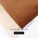 A close up detail of the corner of a Charley Chau Burrow Bag Dog Bed with burnt orange outer cover in upholstery-quality Velour and plush cream faux-fur lining with a woven brand label showing the Charley Chau logo on a white backdrop.