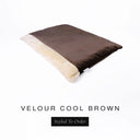 A luxurious Dog Burrow Bag, a sleeping bag style dog bed or snuggle sack style dog bed, with an outer cover in rich brown upholstery-quality Velour with a plush, cream faux-fur lining, and a badge with the colour name Cool Brown on a white background.
