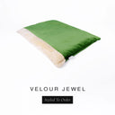 A luxurious Dog Burrow Bag, a sleeping bag style dog bed or snuggle sack style dog bed, with an outer cover in emerald green upholstery-quality Velour with a plush, cream faux-fur lining, and a badge with the colour name Jewel on a white background.