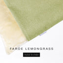 A close up detail of the corner of a Charley Chau Burrow Bag Dog Bed with soft olive green outer cover in woven wool texture upholstery fabric Faroe and plush cream faux-fur lining with a woven brand label showing the Charley Chau logo on a white backdrop.