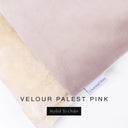 A close up detail of the corner of a Charley Chau Burrow Bag Dog Bed with palest pink outer cover in upholstery-quality Velour and plush cream faux-fur lining with a woven brand label showing the Charley Chau logo on a white backdrop.
