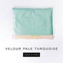 Bespoke snuggle bag style Dog Burrow Bag in a pale turquoise velvet with plush cream faux-fur lining on a white backdrop.