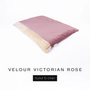 A luxurious Dog Burrow Bag, a sleeping bag style dog bed or snuggle sack style dog bed, with an outer cover in dusty rose pink upholstery-quality Velour with a plush, cream faux-fur lining, and a badge with the colour name Victorian Rose on a white background.
