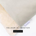 A close up detail of the corner of a Charley Chau Burrow Bag Dog Bed with pale beige outer cover in upholstery-quality Velour and plush cream faux-fur lining with a woven brand label showing the Charley Chau logo on a white backdrop.