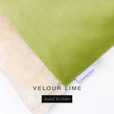 A close up detail of the corner of a Charley Chau Burrow Bag Dog Bed with lime green outer cover in upholstery-quality Velour and plush cream faux-fur lining with a woven brand label showing the Charley Chau logo on a white backdrop.