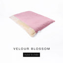 A luxurious Dog Burrow Bag, a sleeping bag style dog bed or snuggle sack style dog bed, with an outer cover in pink upholstery-quality Velour with a plush, cream faux-fur lining, and a badge with the colour name Blossom on a white background.