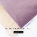 A close up detail of the corner of a Charley Chau Burrow Bag Dog Bed with mid purple outer cover in upholstery-quality Velour and plush cream faux-fur lining with a woven brand label showing the Charley Chau logo on a white backdrop.