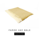 A luxurious Dog Burrow Bag, a sleeping bag style dog bed or snuggle sack style dog bed, with an outer cover in warm straw yellow woven wool texture upholstery fabric Faroe with a plush, cream faux-fur lining, and a badge with the colour name Hay Bale on a white background.