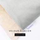 A close up detail of the corner of a Charley Chau Burrow Bag Dog Bed with pale icy grey outer cover in upholstery-quality Velour and plush cream faux-fur lining with a woven brand label showing the Charley Chau logo on a white backdrop.