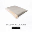 A luxurious Dog Burrow Bag, a sleeping bag style dog bed or snuggle sack style dog bed, with an outer cover in pale taupe upholstery-quality Velour with a plush, cream faux-fur lining, and a badge with the colour name Pale Mink on a white background.