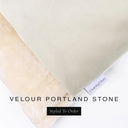 A close up detail of the corner of a Charley Chau Burrow Bag Dog Bed with pale stone grey outer cover in upholstery-quality Velour and plush cream faux-fur lining with a woven brand label showing the Charley Chau logo on a white backdrop.