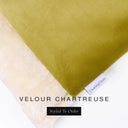 A close up detail of the corner of a Charley Chau Burrow Bag Dog Bed with chartreuse outer cover in upholstery-quality Velour and plush cream faux-fur lining with a woven brand label showing the Charley Chau logo on a white backdrop.