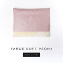 A bespoke snuggle sack style Dog Burrow Bag in a pink woven upholstery fabric with a cream faux-fur lining on a white backdrop.
