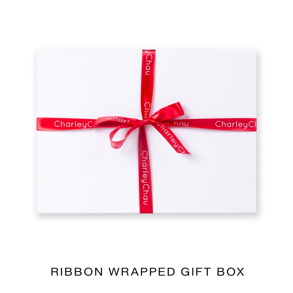 White Gift box wrapped with a red ribbon on a white background