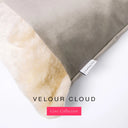 A close up detail of the corner of a Charley Chau Dog Snuggle Bed with pale grey outer cover in upholstery-quality Velour and plush cream faux-fur lining with a woven brand label showing the Charley Chau logo on a white backdrop.