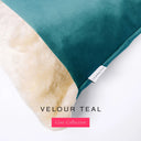 A close up detail of the corner of a Charley Chau Dog Snuggle Bed with deep teal outer cover in upholstery-quality Velour and plush cream faux-fur lining with a woven brand label showing the Charley Chau logo on a white backdrop.