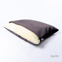 Dog cave luxury Dog Snuggle Bed by Charley Chau in a dark brown/black woven upholstery fabric with plush cream lining on a white backdrop.