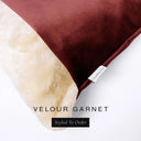 Close up of the corner of a luxury Dog Snuggle Bed, a cave bed style dog bed or sleeping bag style dog bed, with a deep burgundy red upholstery-quality velour / velvet outer cover and plush cream faux-fur lining, showing a Charley Chau designer brand label on the dog bed, on a white background.