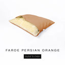 A Charley Chau Snuggle Bed, a cave bed or sleeping bag style dog bed made with a orange woven upholstery-quality fabric with cream, plush, faux-fur lining on a white backdrop.