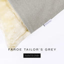 Corner detail of a luxury Dog Snuggle Bed, a sleeping bag style dog bed or cave bed style dog bed, with pale grey colored upholstery quality outer cover and plush cream faux-fur lining with Charley Chau's designer brand label.