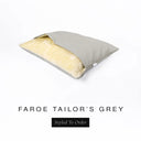 A Charley Chau Snuggle Bed, a cave bed or sleeping bag style dog bed made with a pale grey woven upholstery-quality fabric with cream, plush, faux-fur lining on a white backdrop.