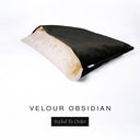 A luxury Dog Snuggle Bed, a cave bed style dog bed or sleeping bag dog bed, in upholstery-quality black Velour with a cream plush lining on a white backdrop.