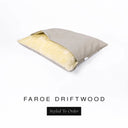 A Charley Chau Snuggle Bed, a cave bed or sleeping bag style dog bed made with a pale beige woven upholstery-quality fabric with cream, plush, faux-fur lining on a white backdrop.