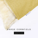 Corner detail of a luxury Dog Snuggle Bed, a sleeping bag style dog bed or cave bed style dog bed, with yellow colored upholstery quality outer cover and plush cream faux-fur lining with Charley Chau's designer brand label.