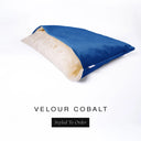 A luxury Dog Snuggle Bed, a cave bed style dog bed or sleeping bag dog bed, in upholstery-quality bright cobalt blue Velour with a cream plush lining on a white backdrop.
