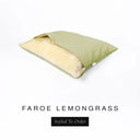 A Charley Chau Snuggle Bed, a cave bed or sleeping bag style dog bed made with a yellow-green woven upholstery-quality fabric with cream, plush, faux-fur lining on a white backdrop.