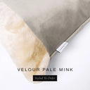 Close up of the corner of a luxury Dog Snuggle Bed, a cave bed style dog bed or sleeping bag style dog bed, with a pale taupe upholstery-quality velour / velvet outer cover and plush cream faux-fur lining, showing a Charley Chau designer brand label on the dog bed, on a white background.