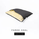 A Charley Chau Snuggle Bed, a cave bed or sleeping bag style dog bed made with a black woven upholstery-quality fabric with cream, plush, faux-fur lining on a white backdrop.