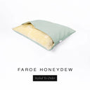 A Charley Chau Snuggle Bed, a cave bed or sleeping bag style dog bed made with a pale green woven upholstery-quality fabric with cream, plush, faux-fur lining on a white backdrop.