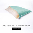 A luxury Dog Snuggle Bed, a cave bed style dog bed or sleeping bag dog bed, in upholstery-quality pale turquoise blue Velour with a cream plush lining on a white backdrop.