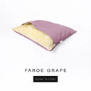 A Charley Chau Snuggle Bed, a cave bed or sleeping bag style dog bed made with a pale purple woven upholstery-quality fabric with cream, plush, faux-fur lining on a white backdrop.