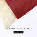 Corner detail of a luxury Dog Snuggle Bed, a sleeping bag style dog bed or cave bed style dog bed, with dark red colored upholstery quality outer cover and plush cream faux-fur lining with Charley Chau's designer brand label.