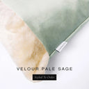 Close up of the corner of a luxury Dog Snuggle Bed, a cave bed style dog bed or sleeping bag style dog bed, with a pale sage green upholstery-quality velour / velvet outer cover and plush cream faux-fur lining, showing a Charley Chau designer brand label on the dog bed, on a white background.