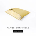 A Charley Chau Snuggle Bed, a cave bed or sleeping bag style dog bed made with a yellow woven upholstery-quality fabric with cream, plush, faux-fur lining on a white backdrop.