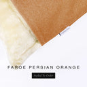 Corner detail of a luxury Dog Snuggle Bed, a sleeping bag style dog bed or cave bed style dog bed, with orange colored upholstery quality outer cover and plush cream faux-fur lining with Charley Chau's designer brand label.