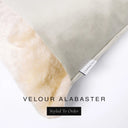 Corner detail of a luxury Dog Snuggle Bed, a cave bed style dog bed, with verty pale stone colored velvet outer cover and plush cream faux-fur lining with Charley Chau's designer brand label.