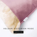 Close up of the corner of a luxury Dog Snuggle Bed, a cave bed style dog bed or sleeping bag style dog bed, with a dusty rose pink upholstery-quality velour / velvet outer cover and plush cream faux-fur lining, showing a Charley Chau designer brand label on the dog bed, on a white background.