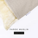 Corner detail of a luxury Dog Snuggle Bed, a sleeping bag style dog bed or cave bed style dog bed, with beige colored upholstery quality outer cover and plush cream faux-fur lining with Charley Chau's designer brand label.