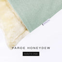 Corner detail of a luxury Dog Snuggle Bed, a sleeping bag style dog bed or cave bed style dog bed, with pale green/blue colored upholstery quality outer cover and plush cream faux-fur lining with Charley Chau's designer brand label.