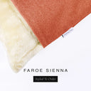 Corner detail of a luxury Dog Snuggle Bed, a sleeping bag style dog bed or cave bed style dog bed, with orange colored upholstery quality outer cover and plush cream faux-fur lining with Charley Chau's designer brand label.