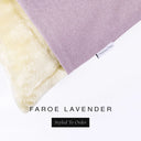 Corner detail of a luxury Dog Snuggle Bed, a sleeping bag style dog bed or cave bed style dog bed, with lavender lavender purple colored upholstery quality outer cover and plush cream faux-fur lining with Charley Chau's designer brand label.