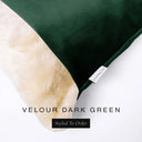 Close up of the corner of a luxury Dog Snuggle Bed, a cave bed style dog bed or sleeping bag style dog bed, with a dark green upholstery-quality velour / velvet outer cover and plush cream faux-fur lining, showing a Charley Chau designer brand label on the dog bed, on a white background.