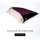 A luxury Dog Snuggle Bed, a cave bed style dog bed or sleeping bag dog bed, in upholstery-quality deep purple Velour with a cream plush lining on a white backdrop.