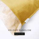 Close up of the corner of a luxury Dog Snuggle Bed, a cave bed style dog bed or sleeping bag style dog bed, with a golden yellow upholstery-quality velour / velvet outer cover and plush cream faux-fur lining, showing a Charley Chau designer brand label on the dog bed, on a white background.